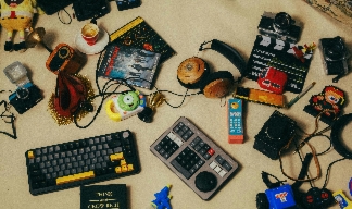 electronic clutter and junk including keyboards and headphones and cassette tapes.